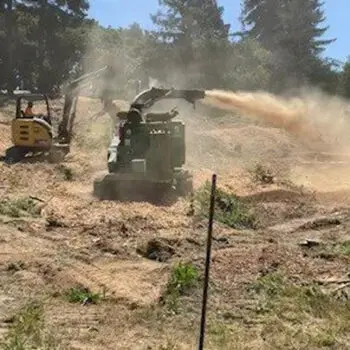 Wood chipper mulching tree debris